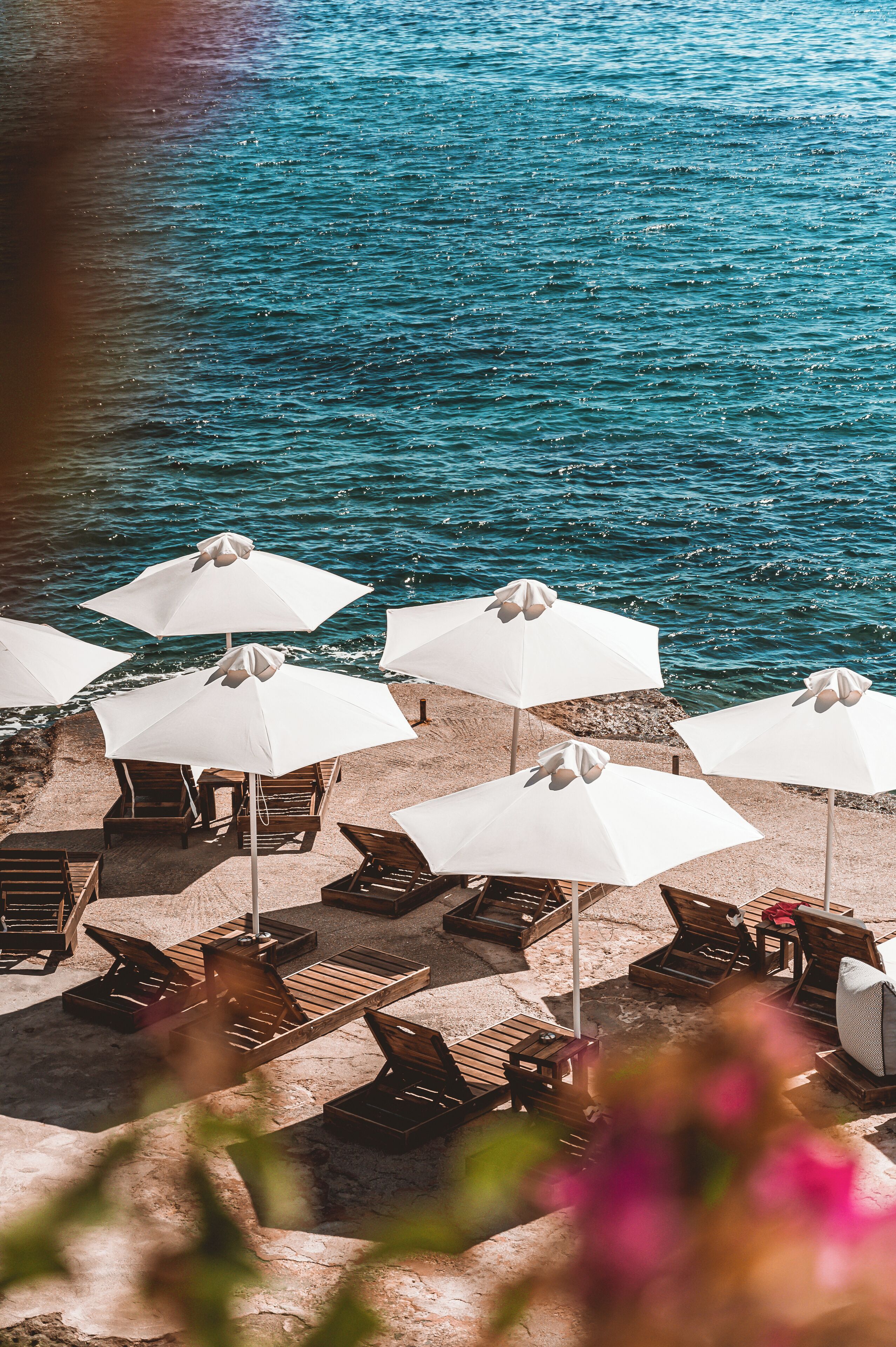 On the beach, black sand, sun-loungers, beach umbrellas