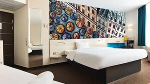 A hotel room with a large bed, a desk, a chair, and a wardrobe. - B&B Hotel Lublin Centrum (Lublin)