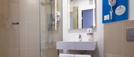 A modern bathroom with a glass-enclosed shower, a white sink, and a blue towel rack.
