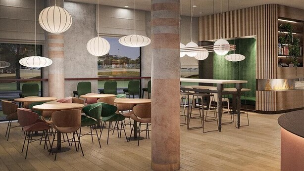 A modern restaurant with round tables and chairs, hanging pendant lights, and a green accent wall. - B&B Hotel Lublin Centrum (Lublin)