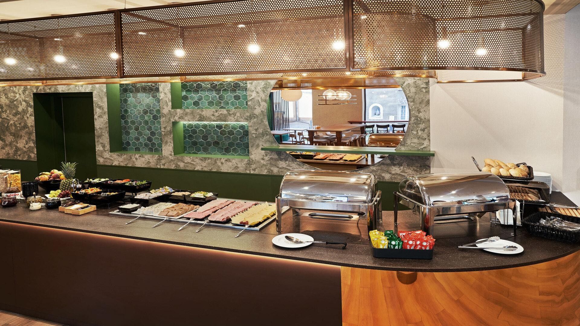 A buffet setup with various food items and a coffee station.