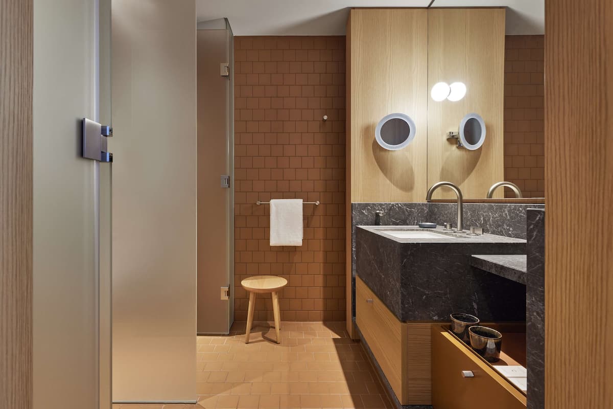 designer toiletries, hair dryer, bathrobes, slippers