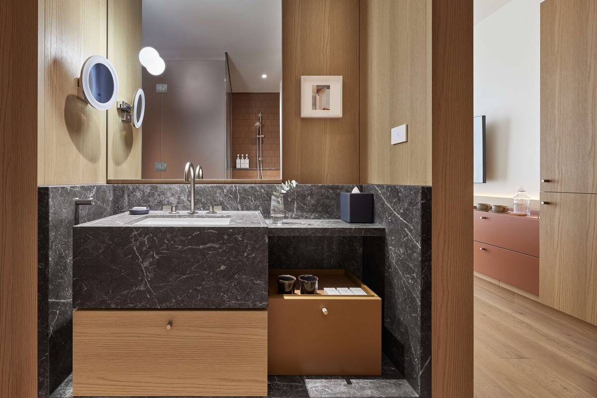 designer toiletries, hair dryer, bathrobes, slippers