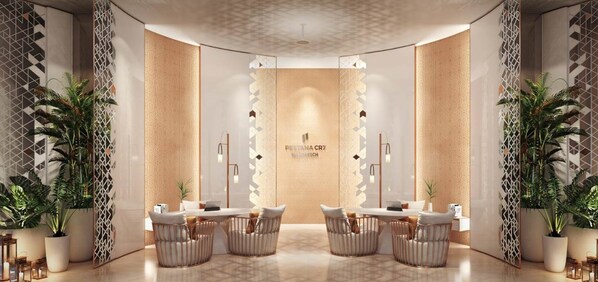 A modern interior with a reception desk, seating area, and decorative plants.