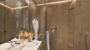 A modern bathroom with a glass shower enclosure, a vanity with a mirror, and a towel rack. - Pestana Cr7 Marrakech (Marrakech)