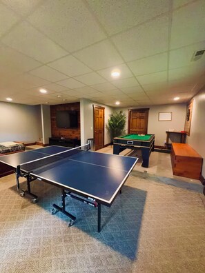 A room with a ping pong table, a pool table, and a billiards table. - ^ Blowing Rock ^ Renovated ^ Sleeps 10 ^ Game Room ^ App Ski Mnt ^ Tweetsie ^ (Blowing Rock)