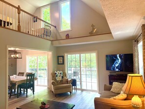 A spacious living room with a high ceiling, a staircase, a dining area, and a television. - ^ Blowing Rock ^ Renovated ^ Sleeps 10 ^ Game Room ^ App Ski Mnt ^ Tweetsie ^ (Blowing Rock)