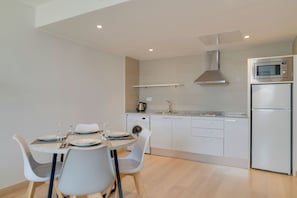 A modern kitchen with white cabinets, a built-in microwave, and a dishwasher. - Pestana Tanger - City Center Hotel Suites & Apartments (Tangier)