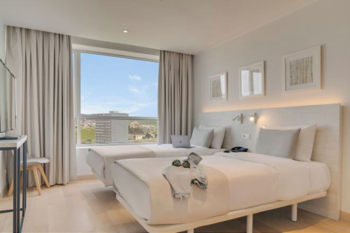 Minibar, laptop workspace, bed sheets