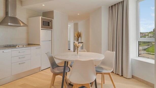 A modern kitchen with a built-in oven, microwave, and stainless steel range hood. - Pestana Tanger - City Center Hotel Suites & Apartments (Tangier)