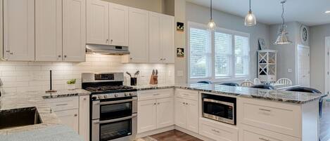 Fridge, stovetop, dishwasher, coffee/tea maker