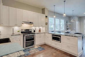 Fridge, stovetop, dishwasher, coffee/tea maker
