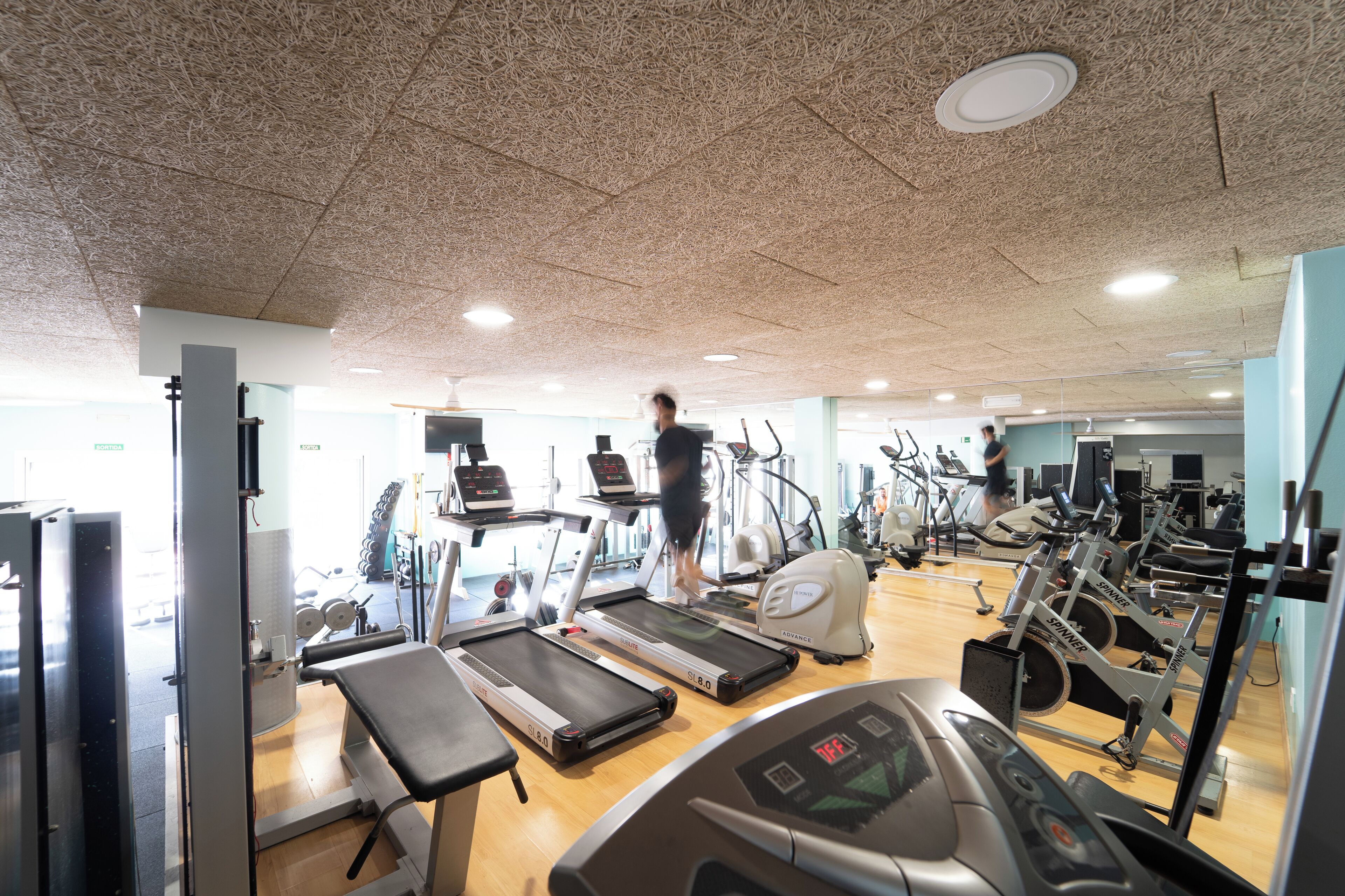 A gym with treadmills, ellipticals, and weight machines.