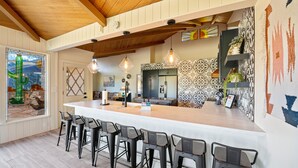 A modern kitchen with a large island, bar stools, pendant lights, and patterned backsplash. - Brand New 2 Bed/2.5 Bath Renovation, Centrally Located in Sedona (Sedona)