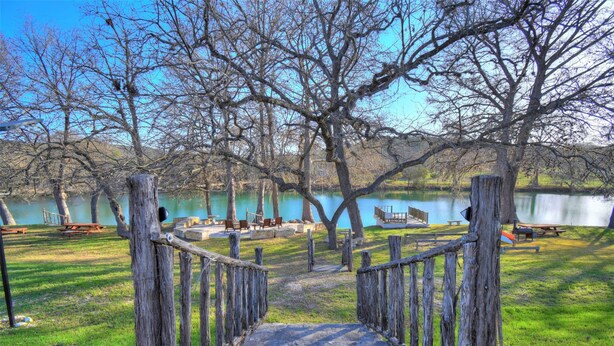 A wooden pathway leading to a lakeside park with picnic tables and benches. - Cabin B (Casa Blanca), 1BR/1BA, Sleeps 4, Porch, Grill (Kerr County)