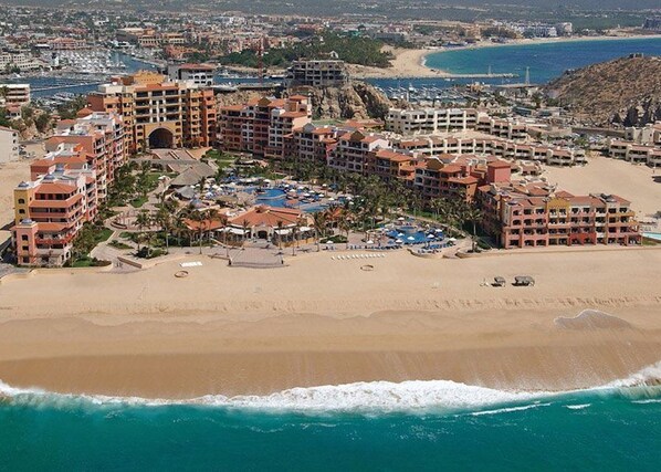 A coastal resort with multiple hotel buildings, a beach, and a marina. - Luxurious Penthouse Suite on the Ridge or Beachfront side- Playa Grande Resort (Cabo San Lucas)
