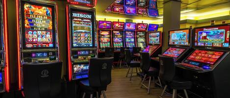 A casino with multiple slot machines and gaming tables.