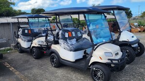 A row of golf carts parked in a lot. - North Finger Private Villa in Paradise (Jolly Harbour)