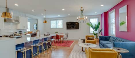 A modern apartment with a kitchen, dining area, and living room.