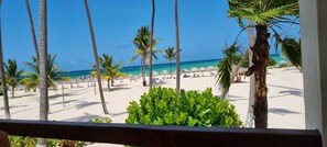 A beach with palm trees and a clear blue sky. - Stanza Mare B-201 Beach Front Bavaro, Punta Cana ,Best View Fully Equipped 3R-3B (Punta Cana)