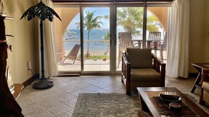 A room with a view of the ocean, a chair, a table, and a floor lamp. - Oceanaire 4 - Amazing Oceanfront Views & Free use of Kayaks (San Pedro)