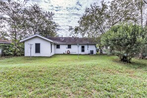 A single-story house with a front yard and a small tree.