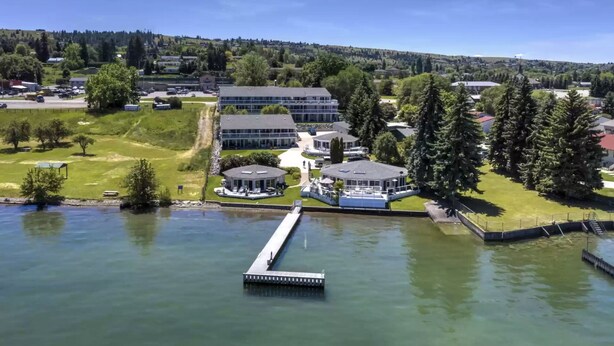A lakeside property with a dock, a pavilion, and a building complex.