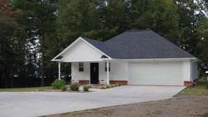 A single-story house with a front porch, a garage, and a driveway. - On Lake Dardanelle, quiet but close to town (Dardanelle)
