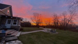 A house with a stone foundation, a front porch, and a lawn. - Located in Ephraim, in the heart of Door County (Sister Bay)