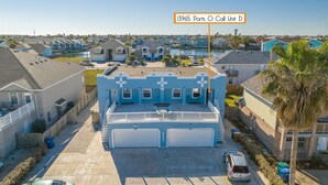 A residential area with a prominent blue building featuring a garage and a balcony.