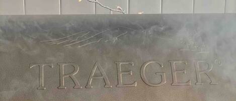 A grill branded with "TRAEGER" on a vehicle.