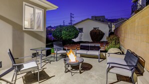 An outdoor patio with a fire pit, seating, and a view of the neighborhood. - RUSTIC/MODERN DESIGN, OASIS CITY GETAWAY/NEAR SFO (South San Francisco)