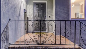 A staircase with a wrought iron railing leading to a door with a doormat. - RUSTIC/MODERN DESIGN, OASIS CITY GETAWAY/NEAR SFO (South San Francisco)
