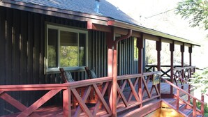 A wooden cabin with a porch and a chimney. - Rustic Chapparal Cabin at Bass Lake Heights (Oakhurst)
