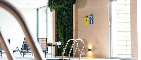 Indoor pool, open 9:00 AM to 10:00 PM, pool umbrellas