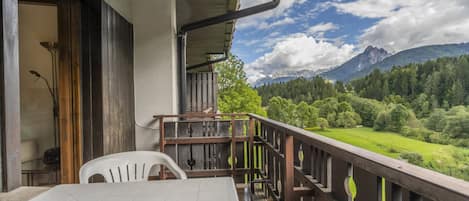 A balcony with a view of a mountainous landscape.