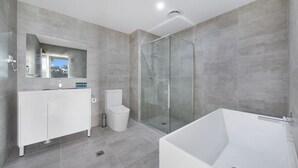 A modern bathroom with a glass-enclosed shower, a large bathtub, and a white vanity with a mirror. - Wentworthville 2 Bedrooms 2 Bathrooms with Free Parking by KozyGuru (Wentworthville)