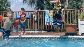 A swimming pool with a wooden deck and a metal fence. - Mountain View Farmhouse, pool/hot tub, fire pit, 4 seasons porch, game room (Millerton)