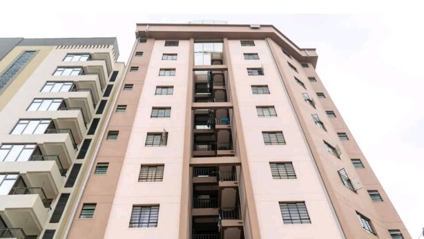 A high-rise building with multiple floors, balconies, and a central stairwell. - Cozy studio with WIFI &Parking in South B (Nairobi)