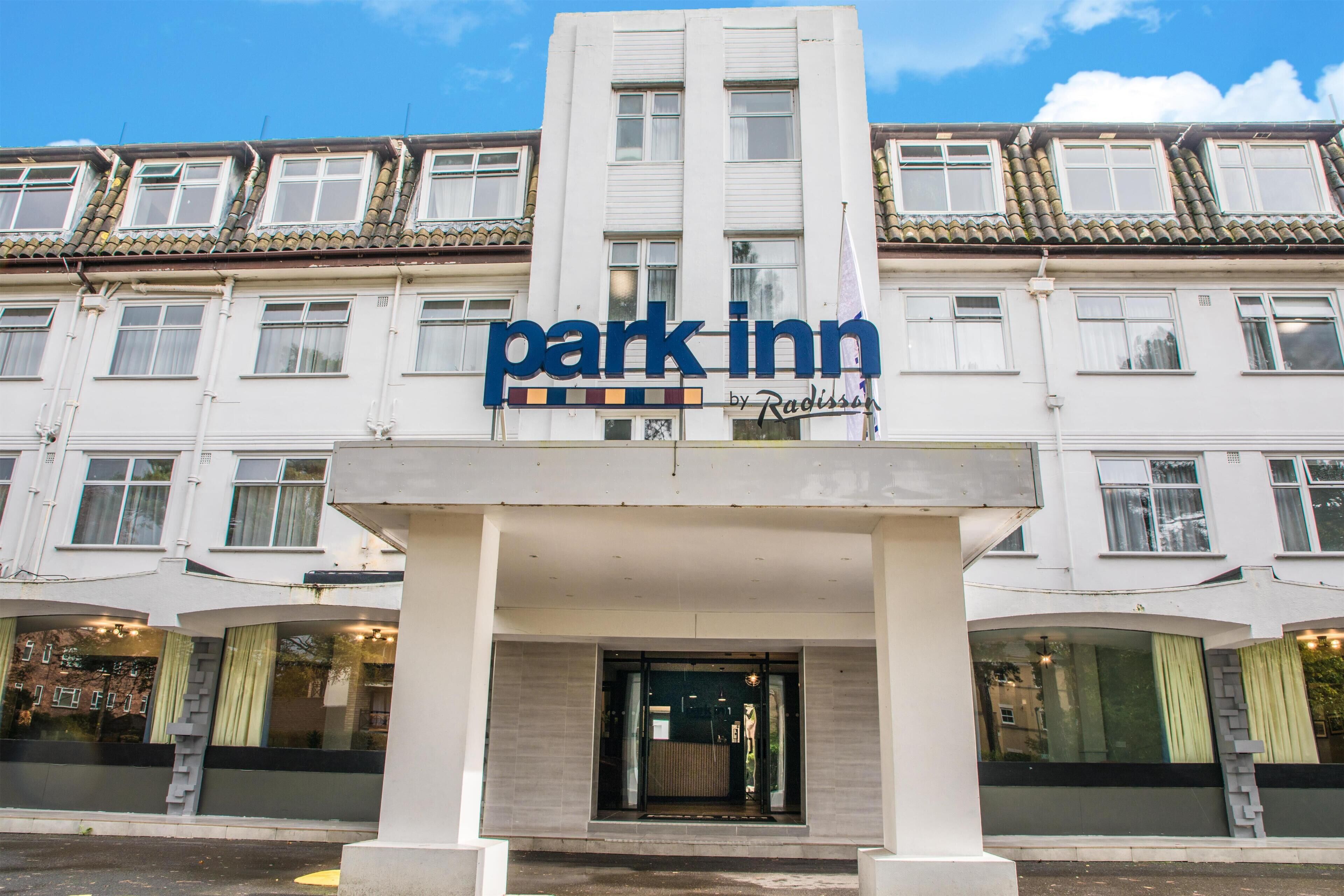 A hotel with a prominent 'park inn' sign above the entrance.