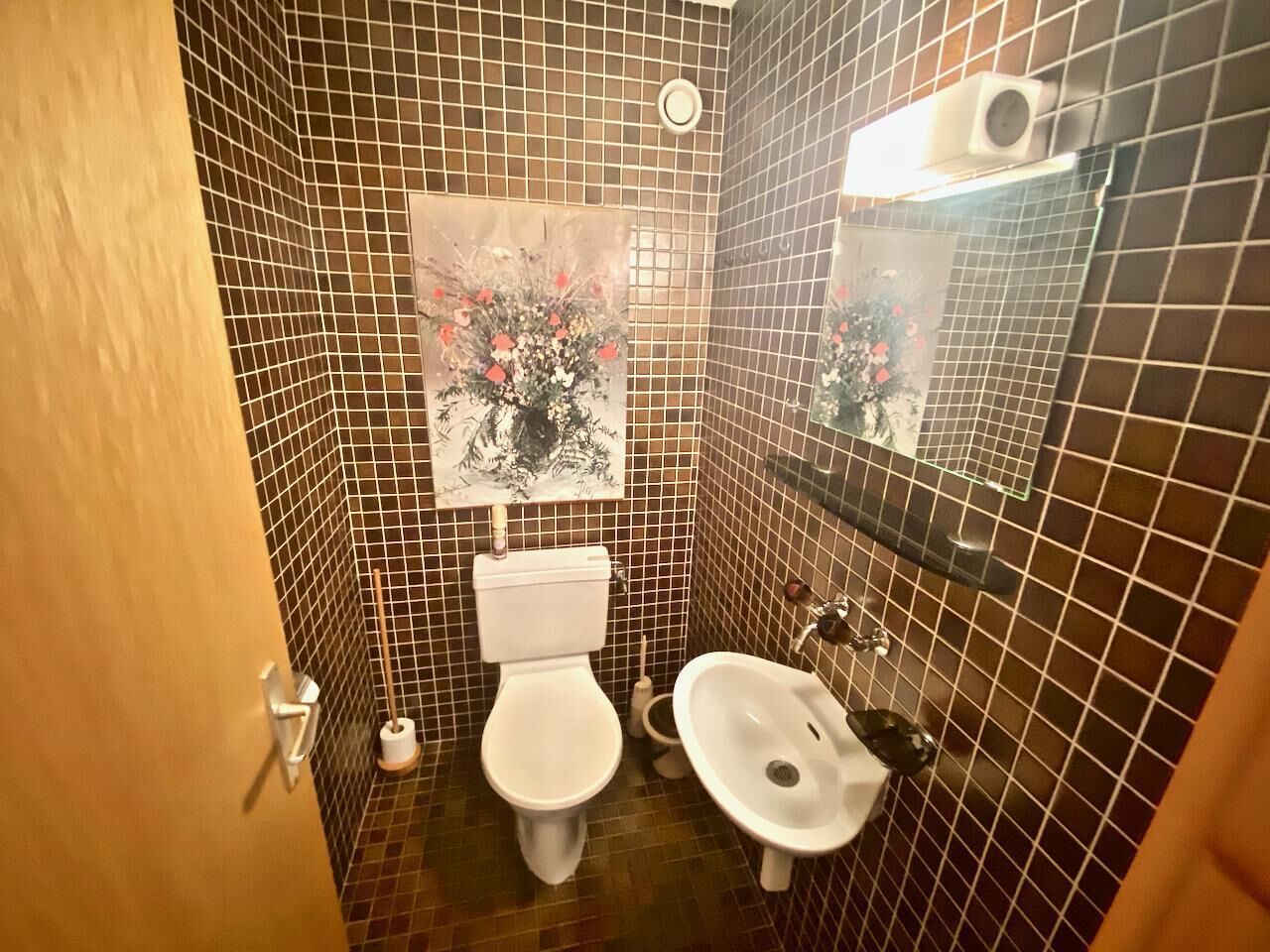 Uma casa de banho pequena com sanita, bidé e lavatório.