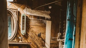 A rustic laundry room with wooden walls and a vintage washing machine. - The Green Egg - Vintage RV Glamping (Terrell)