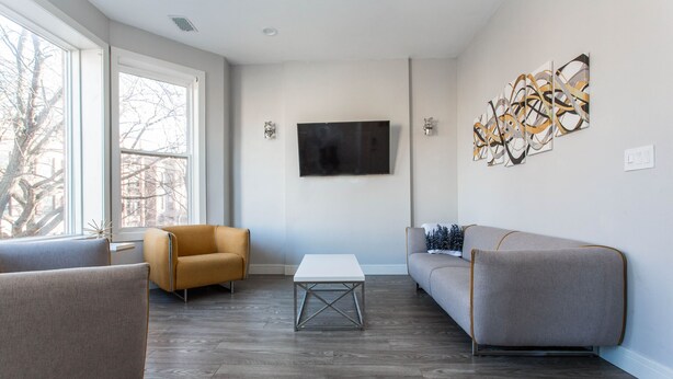 A modern living room with a sofa, armchair, and coffee table. - ❤️ Modern 2BR Apt Right next to Wrigley Field & Transit  (Chicago)