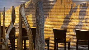 A restaurant interior with wooden chairs and a wall mural of mountains. - Hotel Ski Lodge (Val-d'Isere)