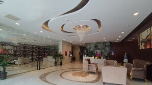 A modern lobby with a marble floor, a reception desk, and seating areas. - Tianjin Crown International Apartments (Tianjin)