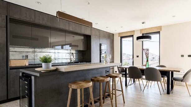 Une cuisine moderne dotée d’un îlot central, de tabourets de bar et d’un coin repas avec des chaises.
