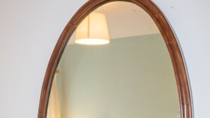 A bedroom with a bed, a nightstand, a lamp, and a mirror. - Sydney Wharf House (Bath)