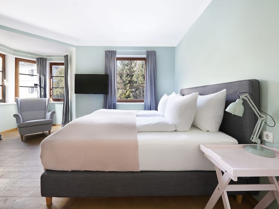 Premium bedding, laptop workspace, iron/ironing board