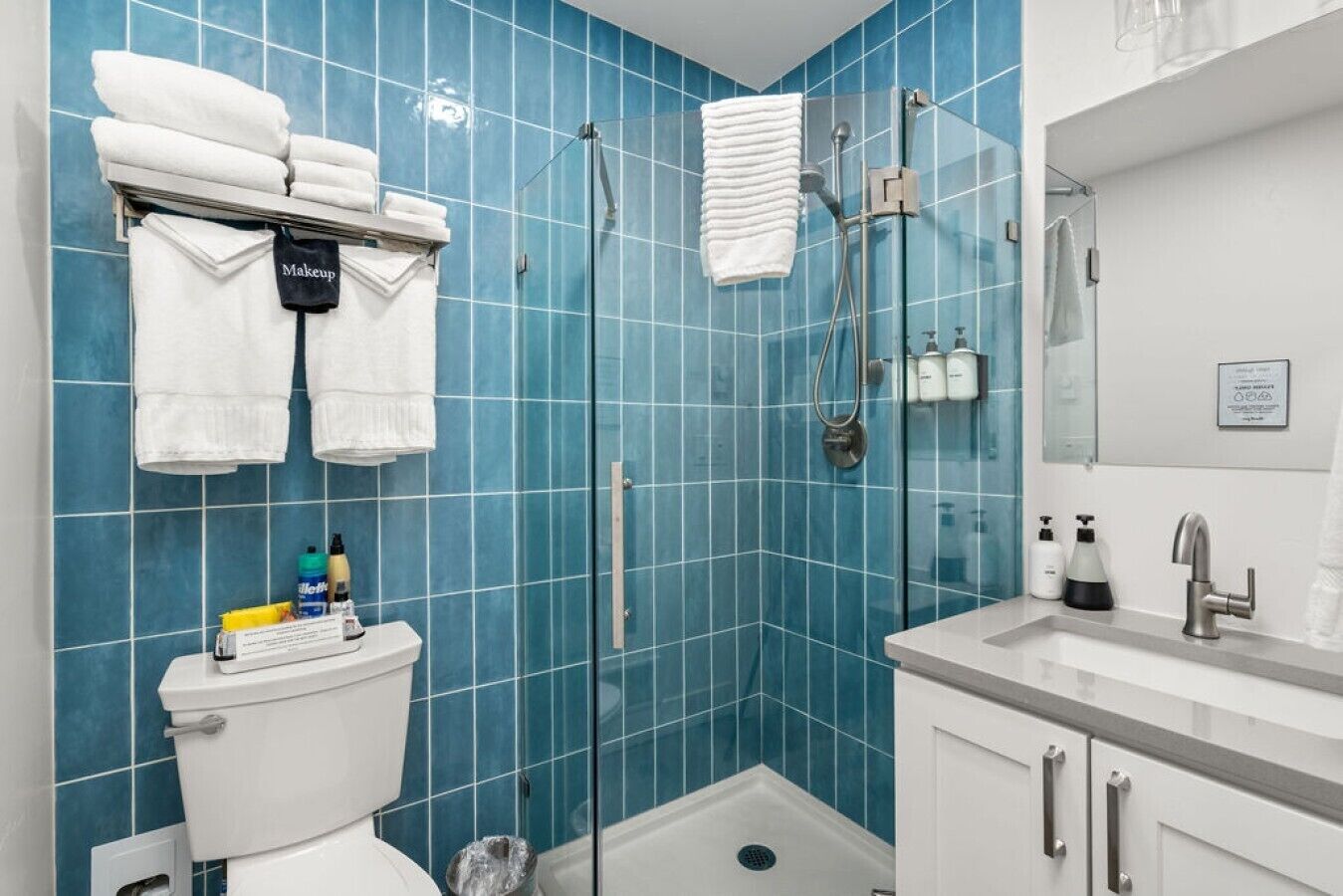 A bathroom with a toilet, a shower, and a sink.