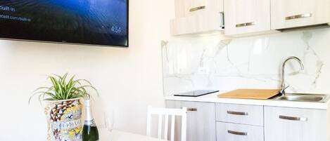 Fridge, microwave, coffee/tea maker, cookware/dishes/utensils